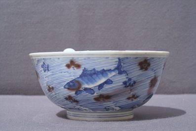 A Chinese blue and underglaze red bowl with carps and marine animals, Xuande mark, Kangxi